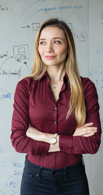 EECS assistant professor Raluca Popa in front of whiteboard