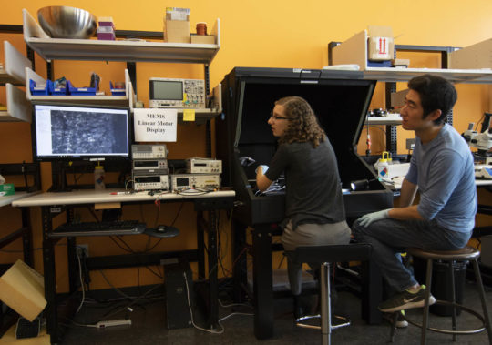 Graduate students Rachel Zoll and Oliver Chen prepare electrodes in the Swarm Lab