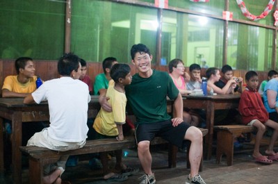 Teacher and students wait for dinner to be served