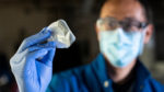 Graduate student Ivan Jayapurna with a sample film of PCL (polycaprolactone), a new, biodegradable polyester plastic.