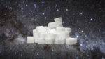Photo illustration of sugar cubes over cosmic background