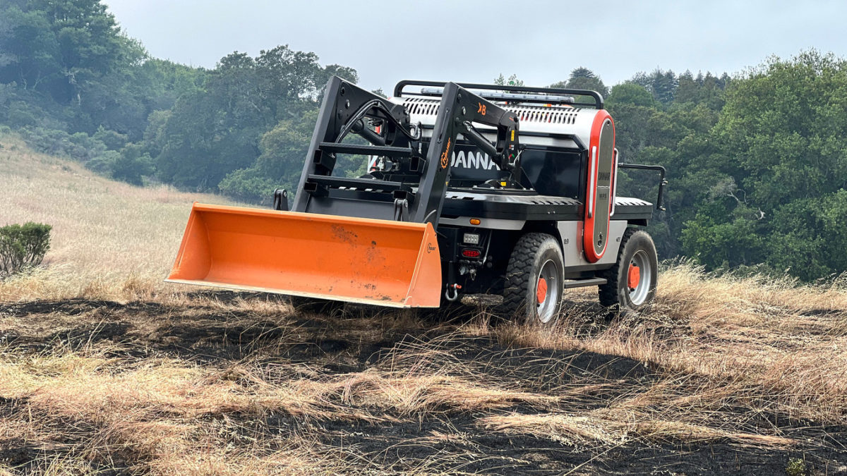 A DANNAR remote-controlled electric utility vehicle configured with a dozer bucket is evaluated for its ability to cut firebreaks and remove vegetation