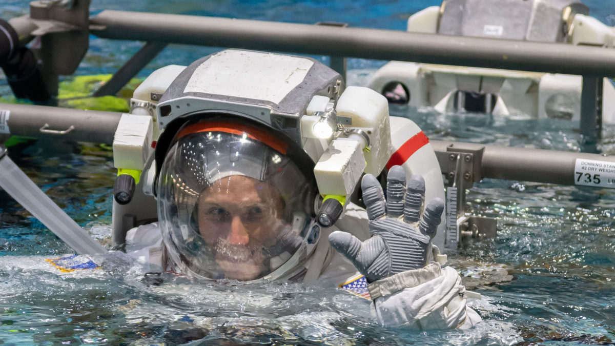 Hoburg is lowered into a pool for spacewalk training