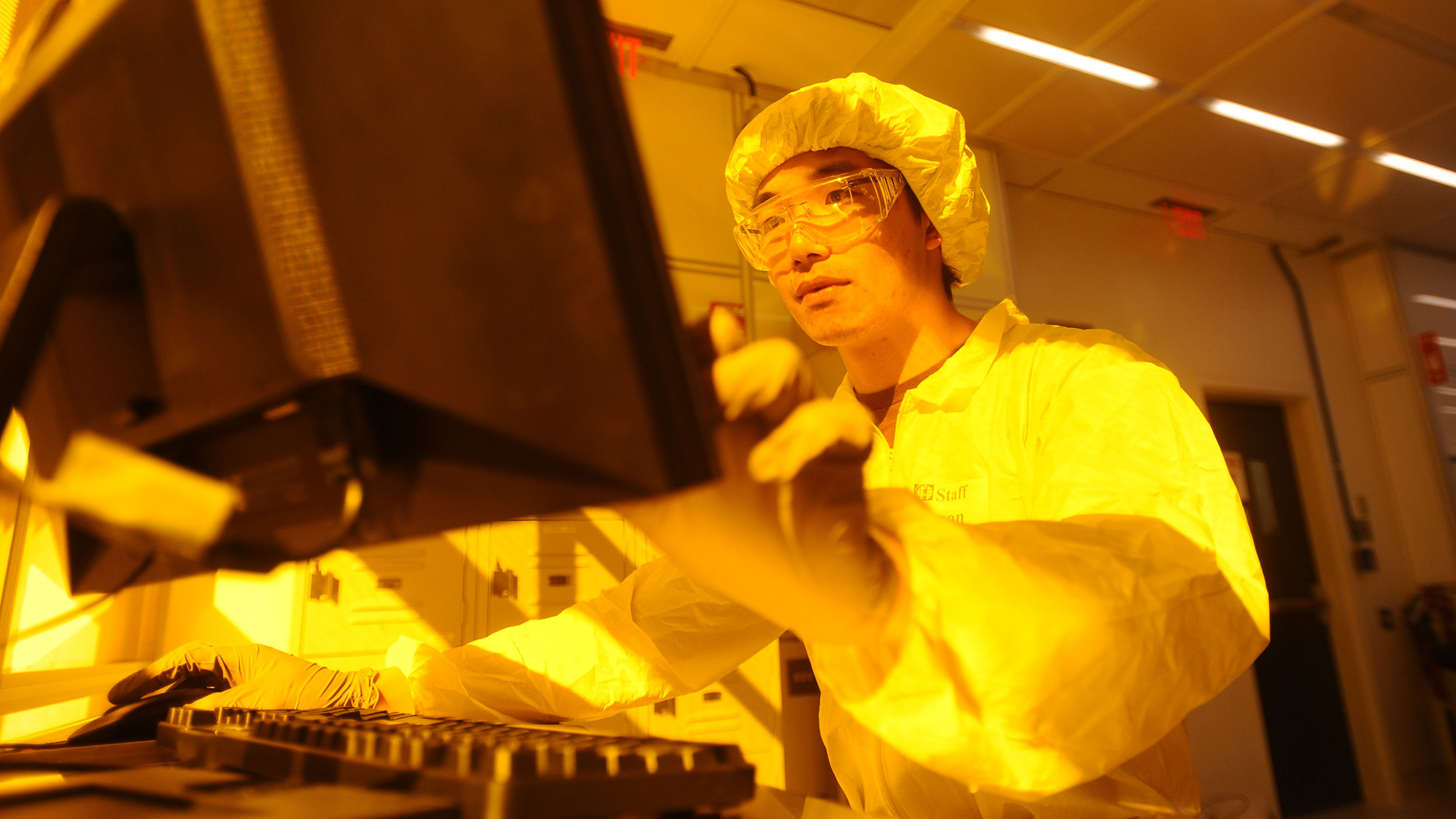 Student at computer in cleanroom