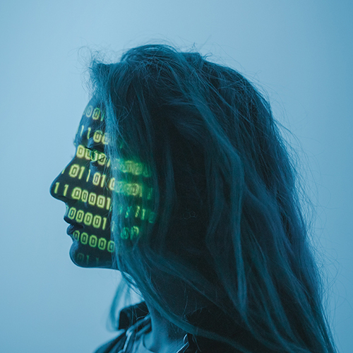 Binary digits projected on a woman's face