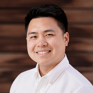 Headshot photo of Coby Lim, a student with short dark hair and a white collared shirt, in front of a blurred brown background.