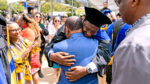 An engineering Ph.D. graduate celebrates with loved ones outside Zellerbach Hall following the Class of 2023 Doctoral Commencement .