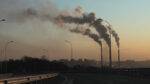 Image of smokestacks emitting vapor into the air.