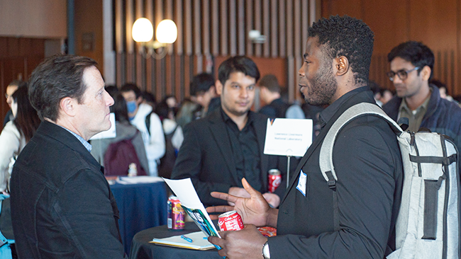 an mtm student speaking to an employer at a networking event 