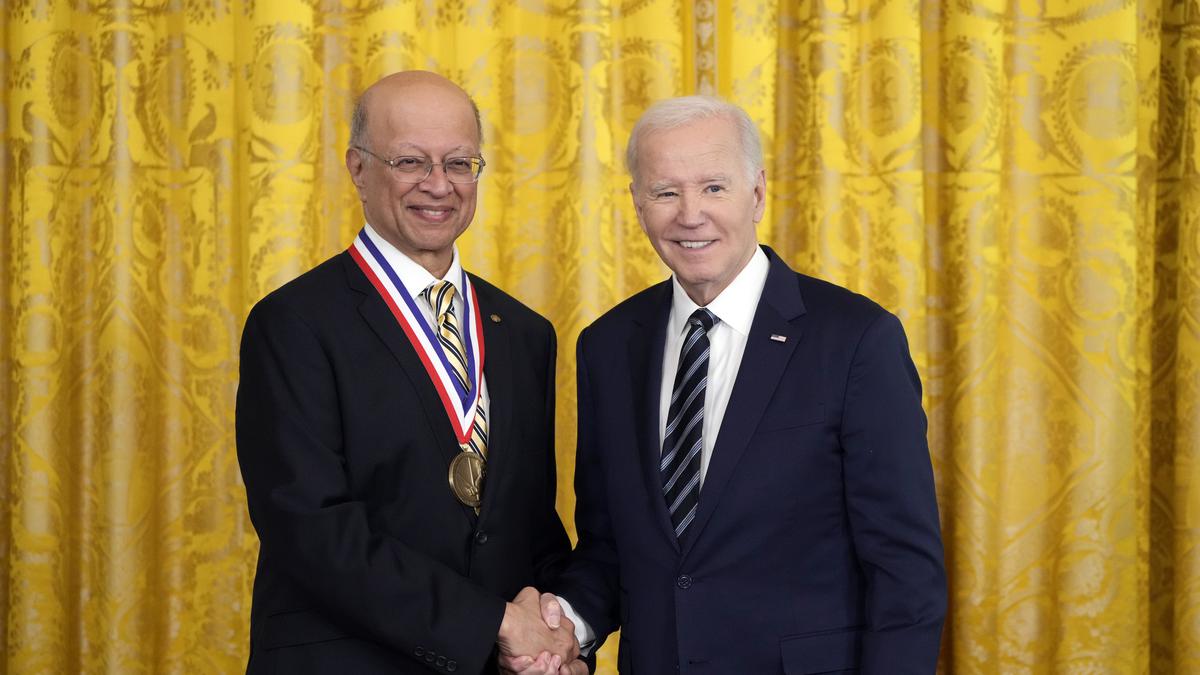 Photo of Ashok Gadgil, wearing the National Medal of Technology and Innovation, shaking hands with President Biden.